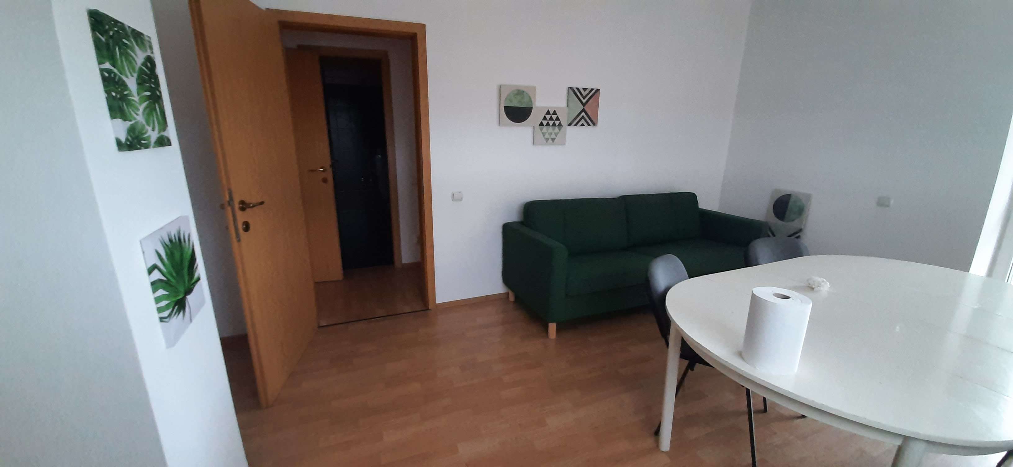 Small office lounge with green couch - apartment-office vibe